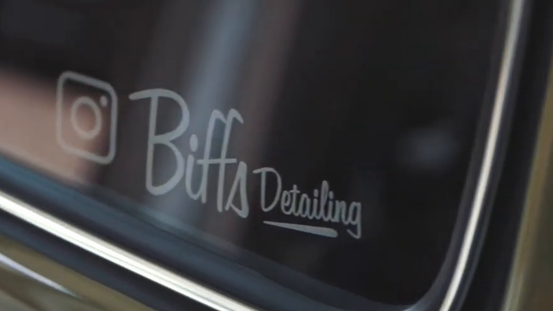 Biff's Detailing logo on a polished car window