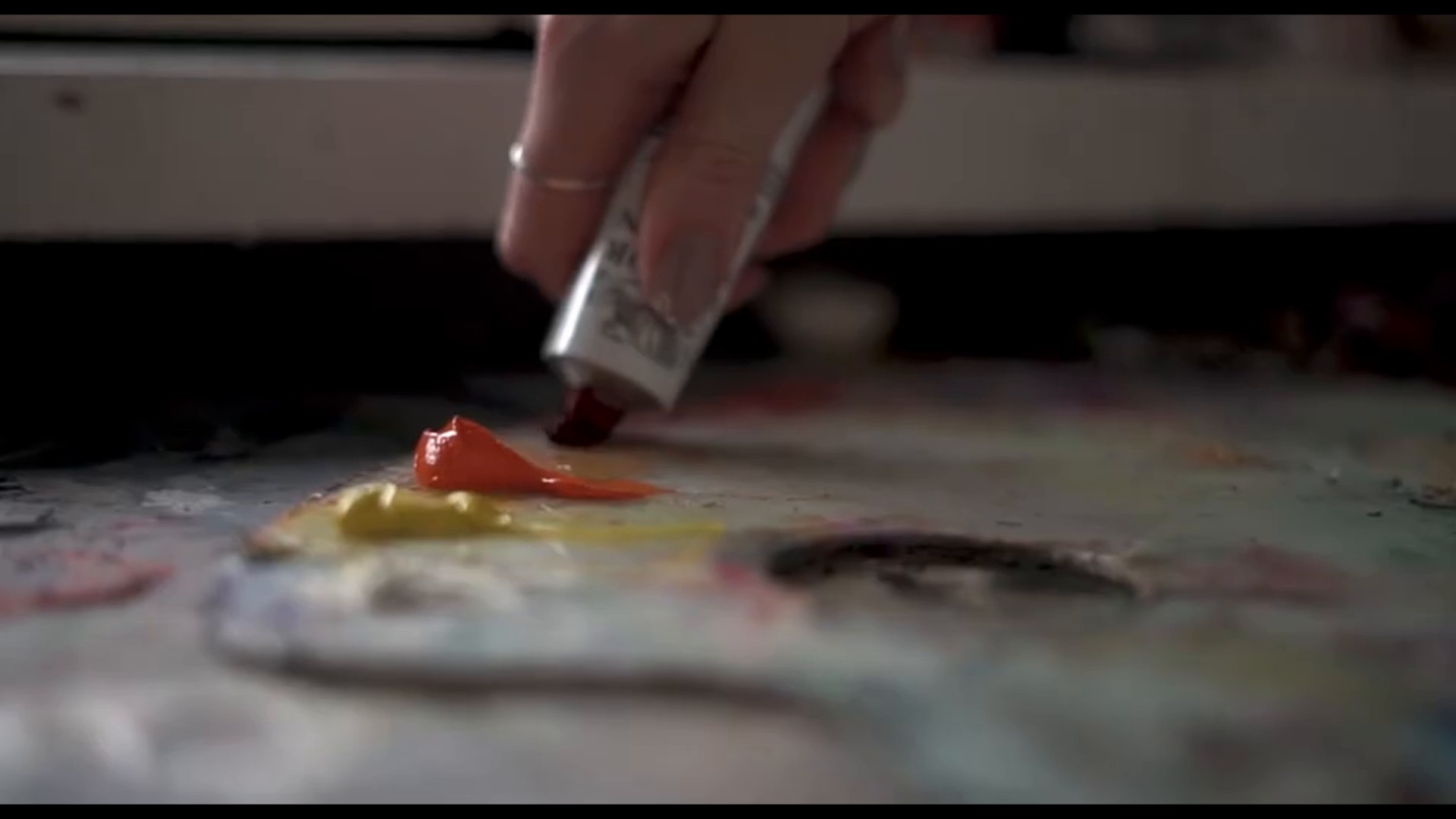 Paint being squeezed onto an artist's palette