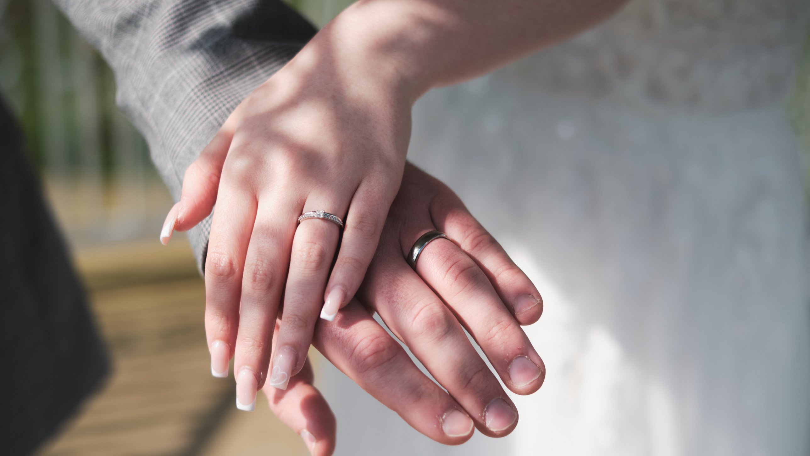 Close-up of hands showing wedding rings